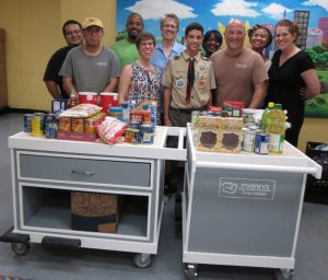 A few members or Manna's team admire Ethan's customized carts