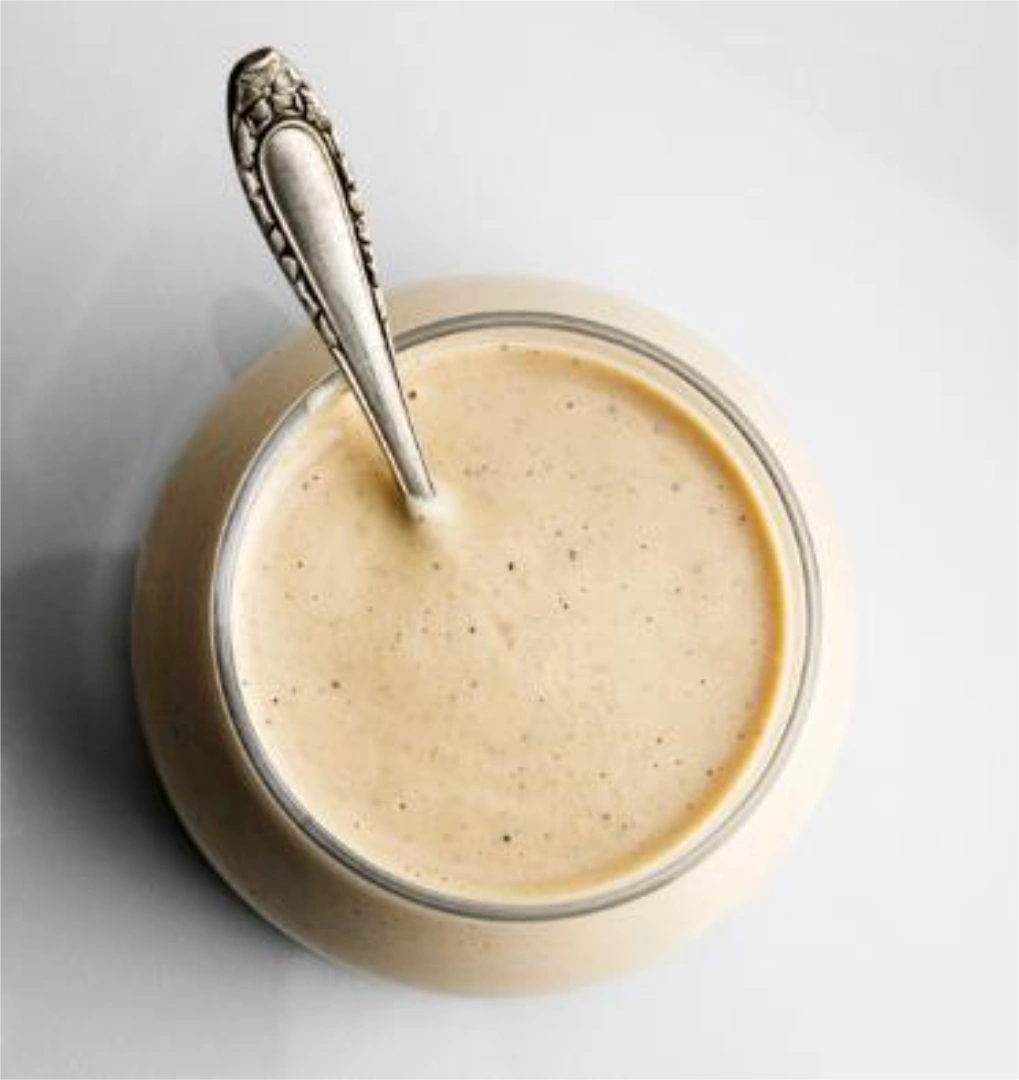 Overhead shot of creamy garlic dressing in a jar