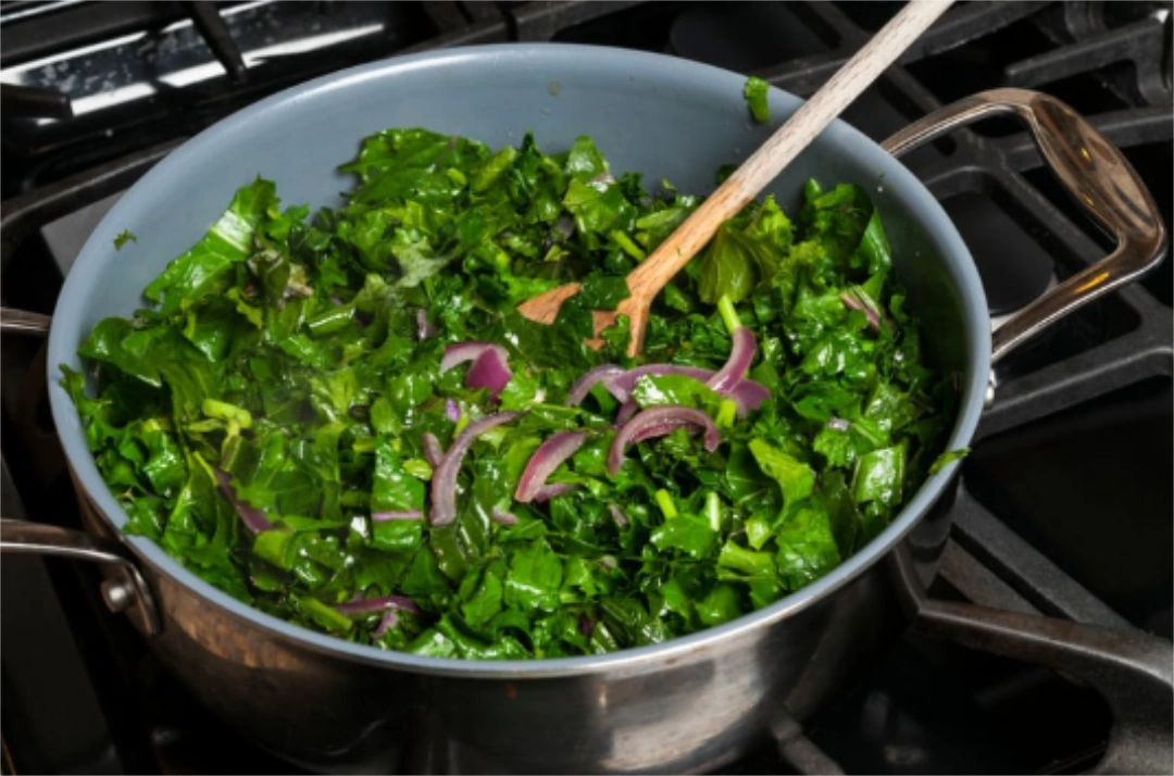 Sauteed kale on a pan on a stove top