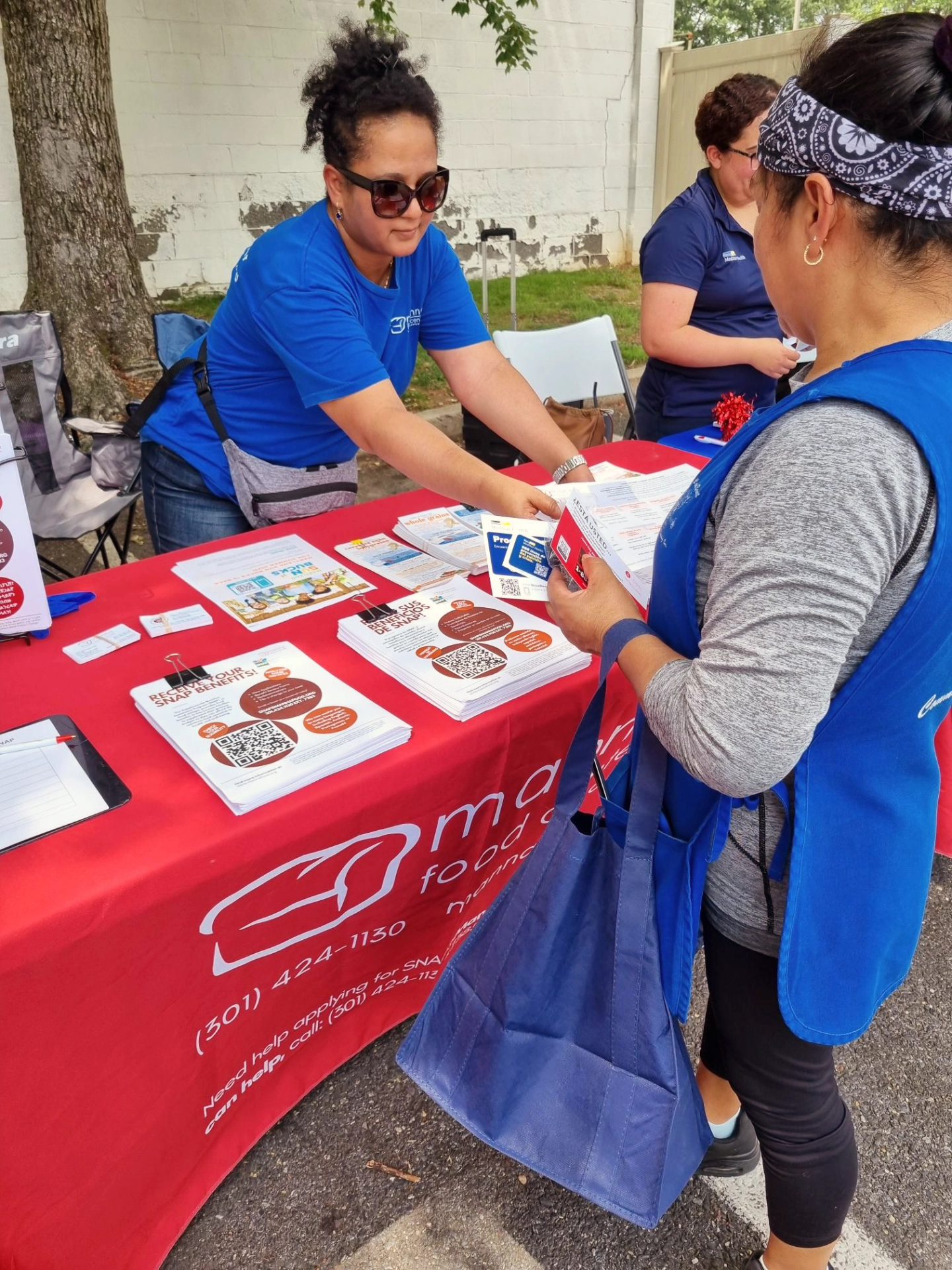 Manna staff distributing flyers as tabling event