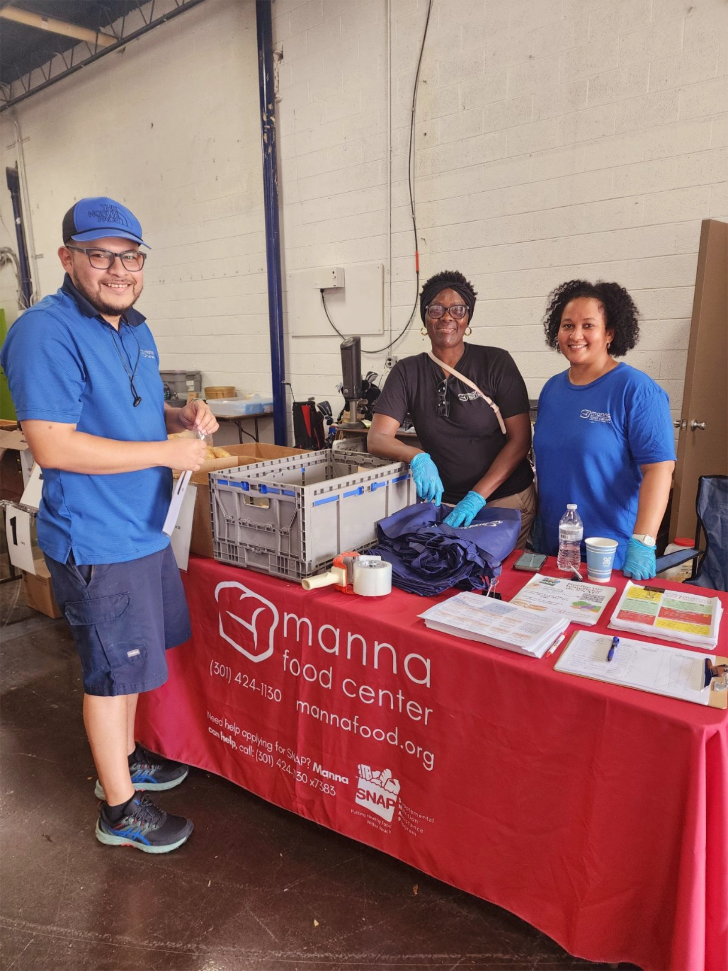Group of three Manna staff tabling at event