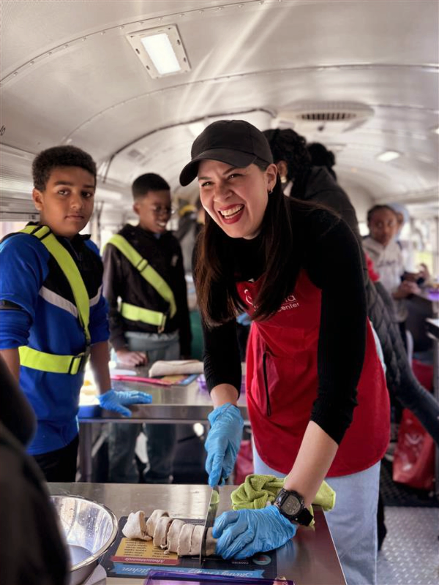 Manna staff teaching cooking class for children