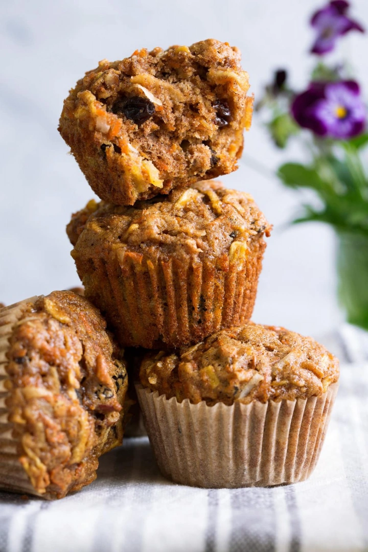 A muffin on its side next to a stack of three muffins