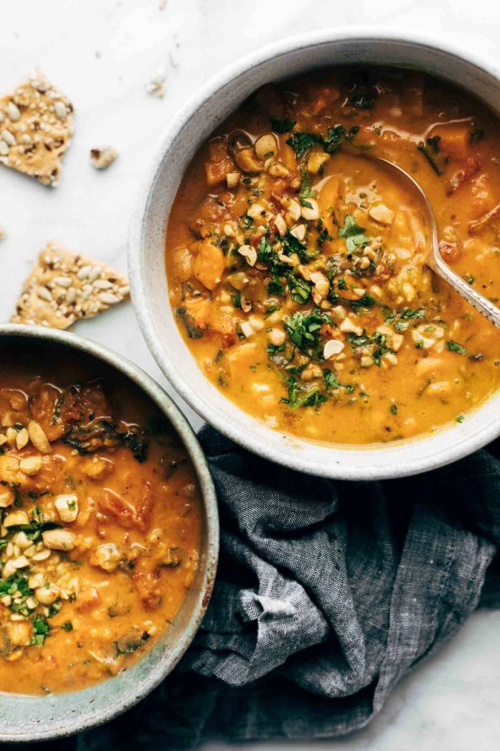 Two bowls of sweet potato peanut stew next to each other